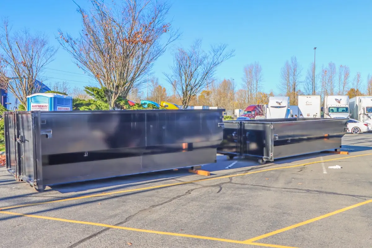 Professional dumpster rental service with roll-off container on residential driveway in Marlboro Village
